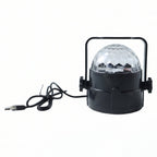 Hand holding the small USB powered star projector light, highlighting its compact size.