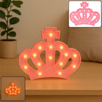 Pink crown LED night light glowing softly, front view