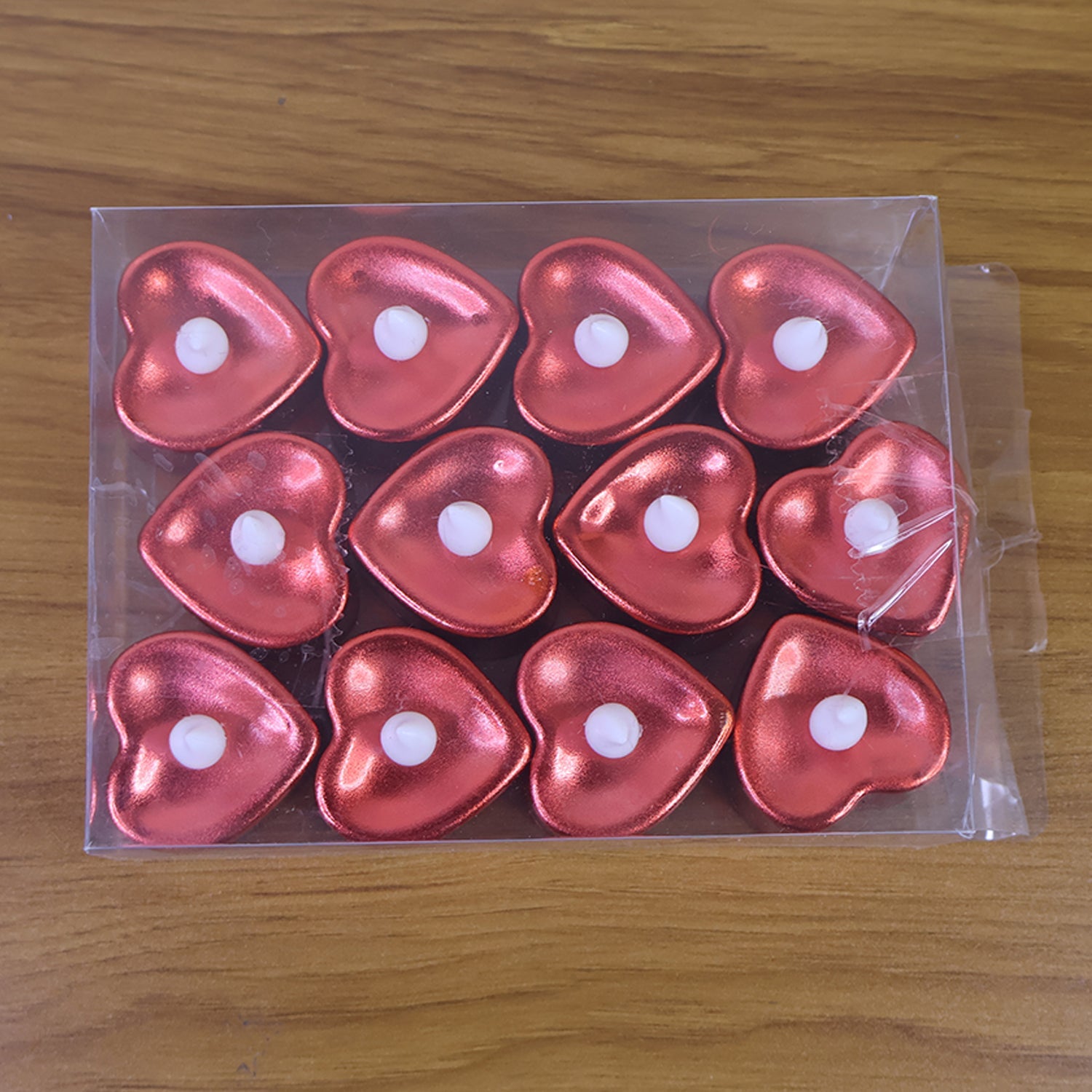 Heart shaped decorative LED tea light candles glowing softly at night