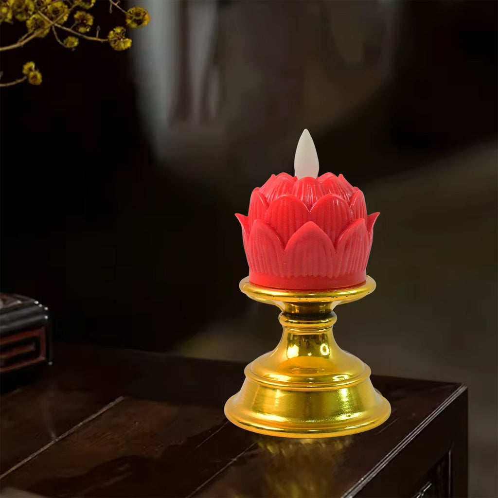 Warm glowing lotus LED flameless candle lit on decorative base for meditation setup
