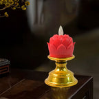 Warm glowing lotus LED flameless candle lit on decorative base for meditation setup