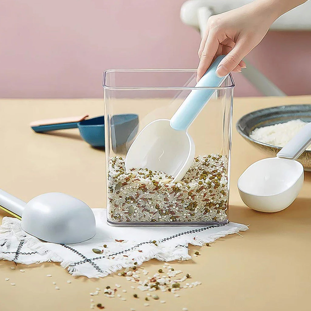 A large plastic measuring spoon shown scooping flour from a bag.