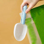 Side view of the ergonomic plastic measuring spoon highlighting its comfortable grip.
