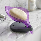 Angled view of a green leaf shape soap tray showing water drainage.
