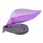 Leaf shape soap holder with a bar of soap next to a kitchen sink.