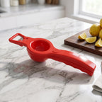 Detailed view of the integrated bottle opener on the kitchen tool.
