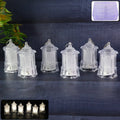 Set of LED hanging lantern style flameless decorative candles glowing with warm white light