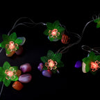 Close view of multi-color LED decorative string light showcasing leaf and flower motifs