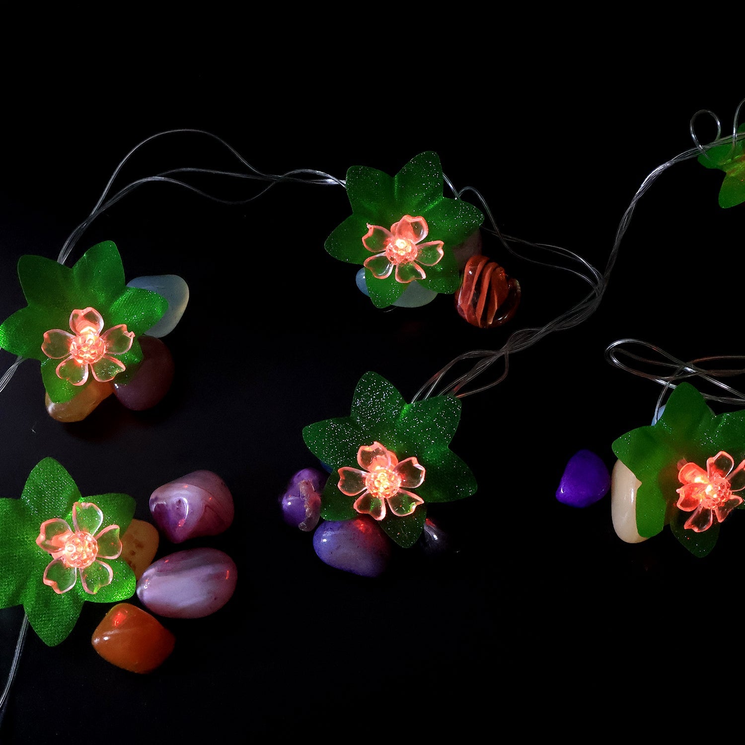 Close view of multi-color LED decorative string light showcasing leaf and flower motifs