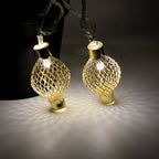 LED string light draped on home decor featuring golden metal balls