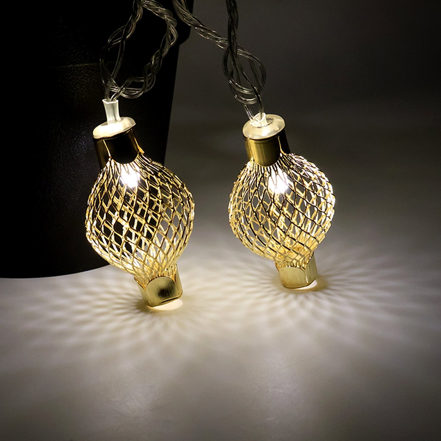 LED string light draped on home decor featuring golden metal balls