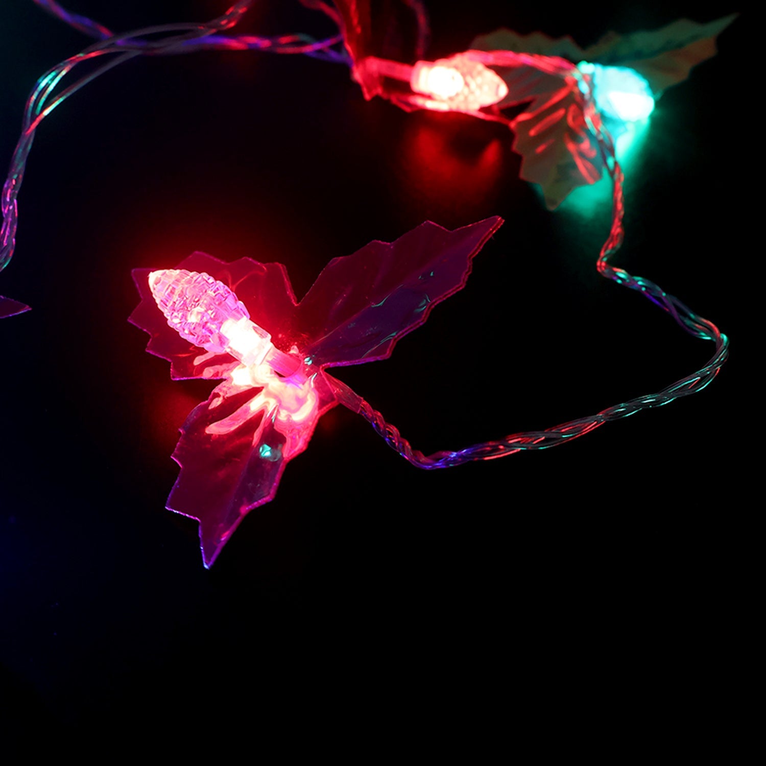 Close view of multicolor LED bulbs on decorative leaf string light