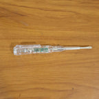 Digital voltage tester pen in use detecting a live wire with LED indication