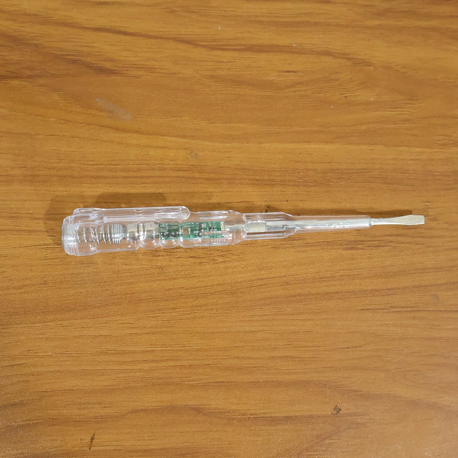 Digital voltage tester pen in use detecting a live wire with LED indication