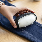 Penguin-shaped eco-friendly lint roller in action