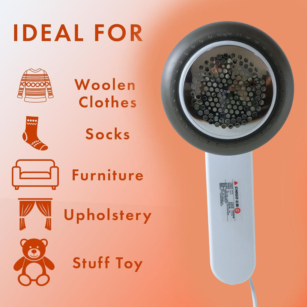 Close-up of fabric shaver lint remover clearing pills from sweater
