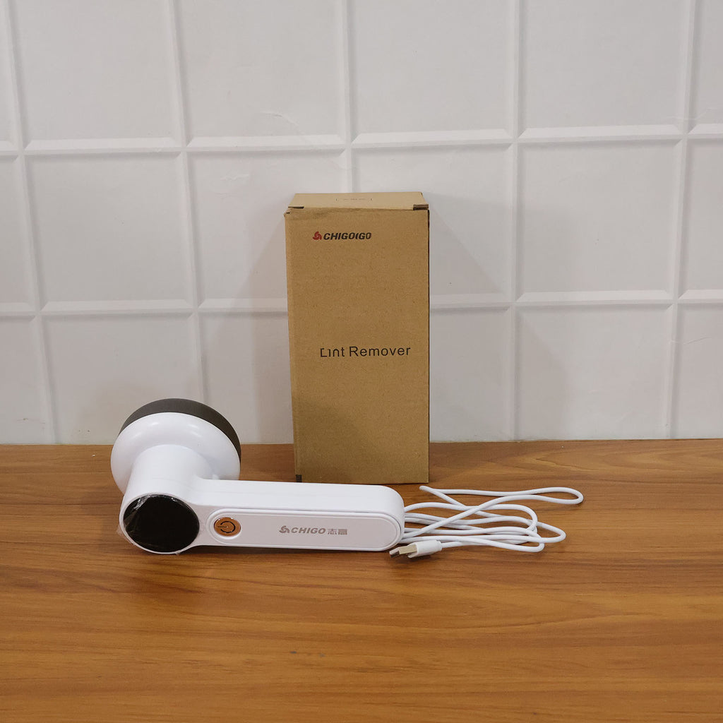 Fabric lint remover in use on home textile for effective fuzz removal