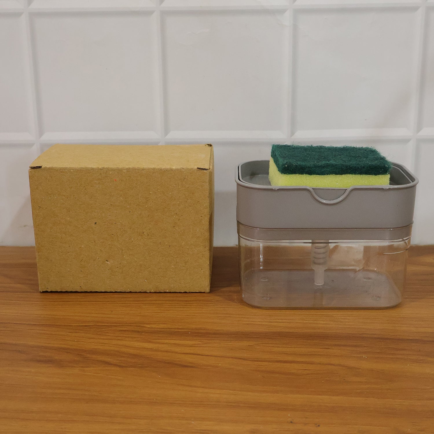 Liquid soap pump actively dispensing soap onto a sponge for quick cleaning.