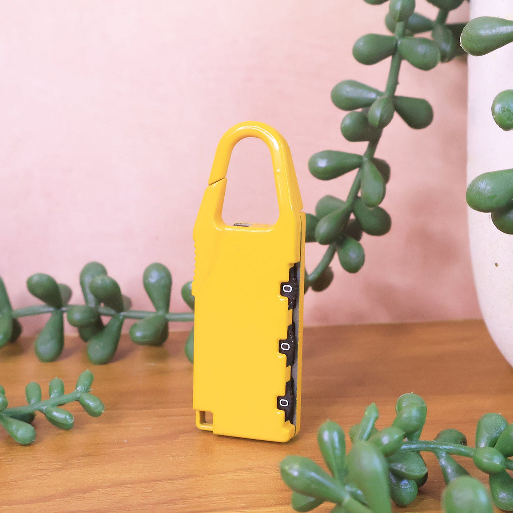 Brightly colored lock attached to luggage zipper for easy identification.