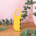 Brightly colored lock attached to luggage zipper for easy identification.