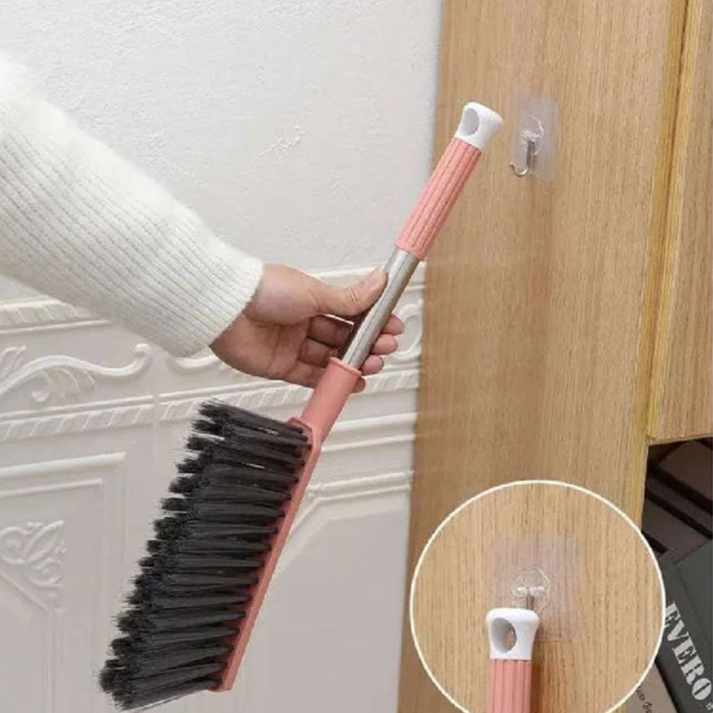 Close-up of soft bristle cleaning brush with long handle