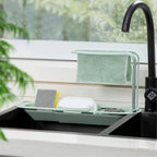 Telescopic sink caddy rack holding multiple kitchen cleaning supplies