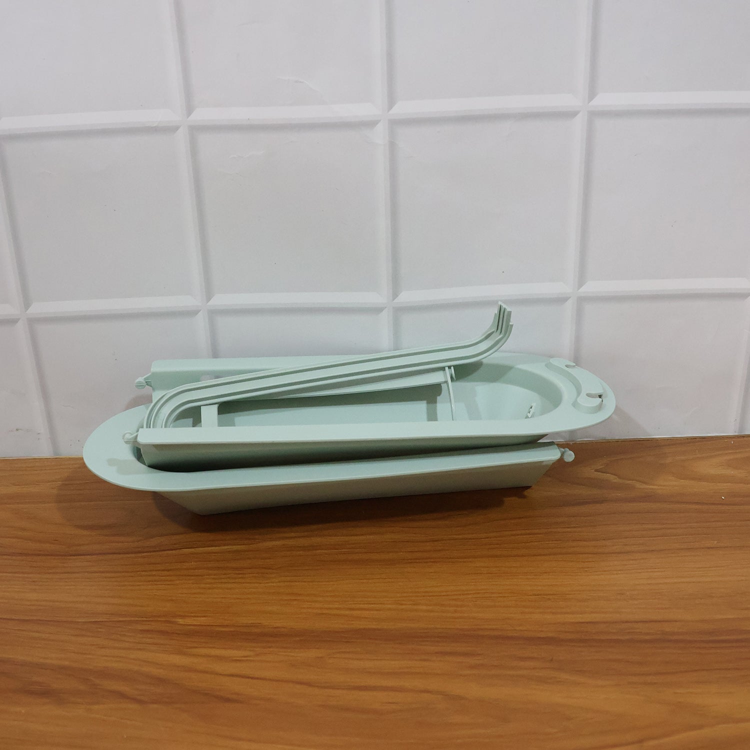 Telescopic sink storage rack installed in modern kitchen setting