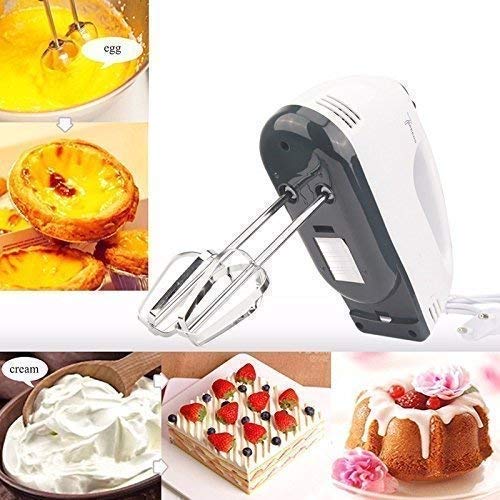 Electric hand mixer with stainless steel beaters on a kitchen counter.