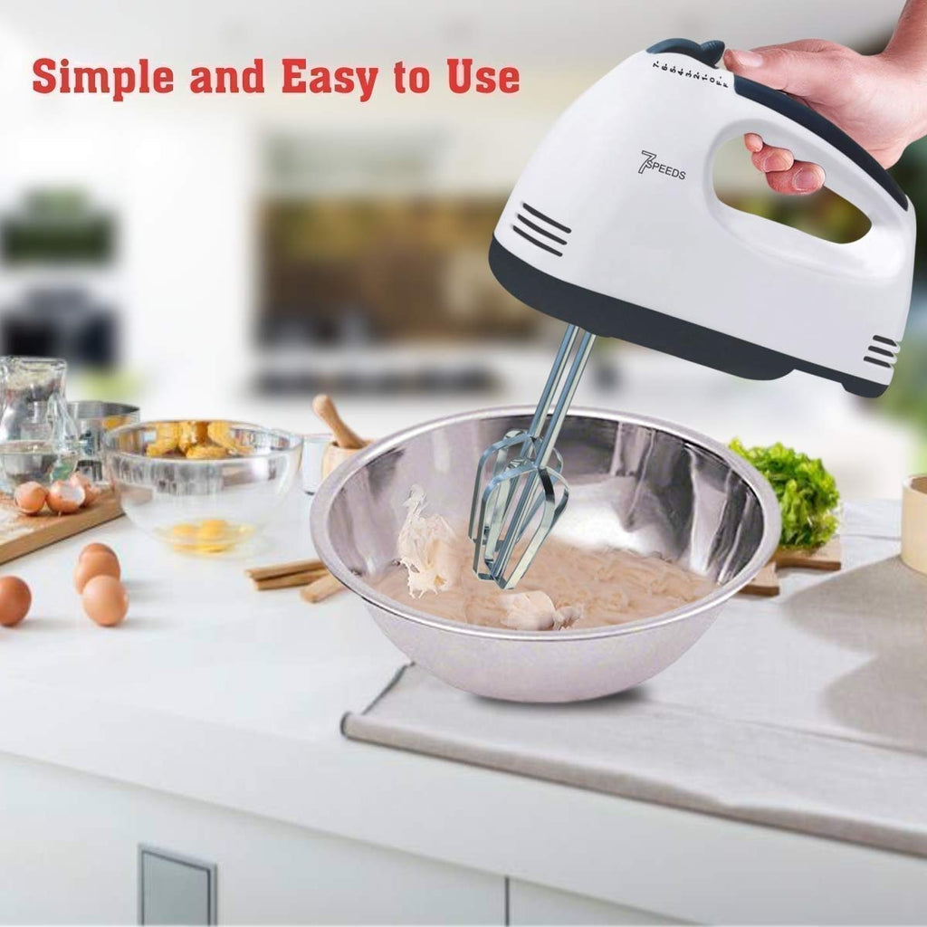 Portable electric mixer for baking showing speed control buttons.