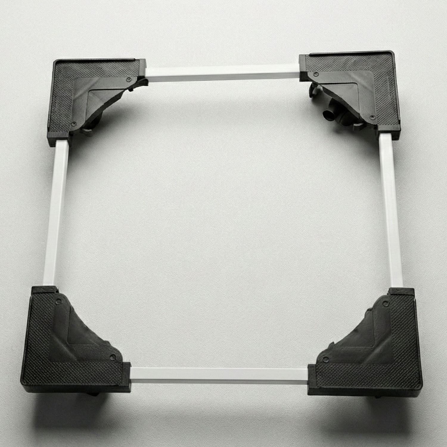 Adjustable appliance stand elevating a washing machine in a laundry area