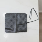 Inside view of foldable makeup brush organizer pouch displaying multiple slots
