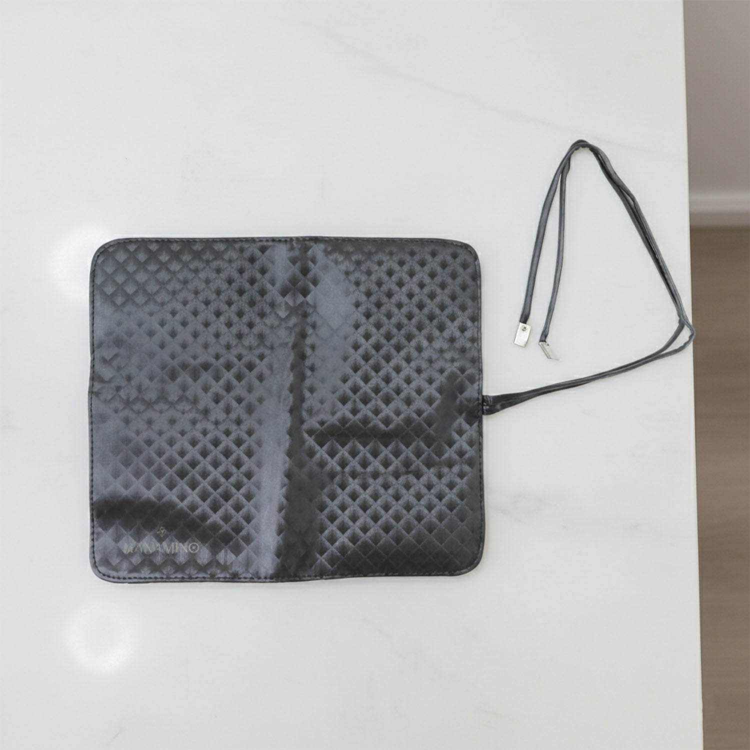 Inside view of foldable makeup brush organizer pouch displaying multiple slots