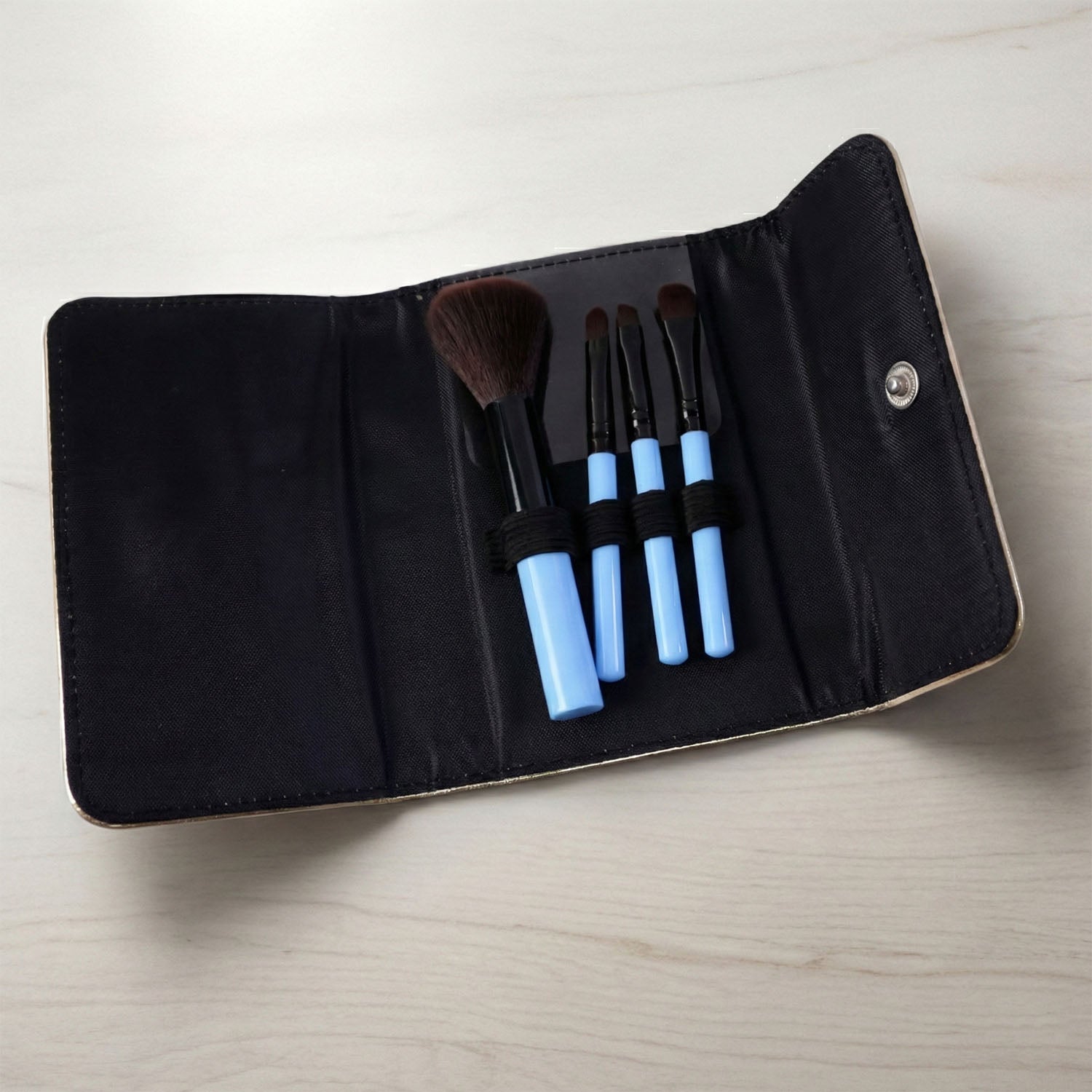 4-in-1 makeup brushes arranged inside the included travel pouch