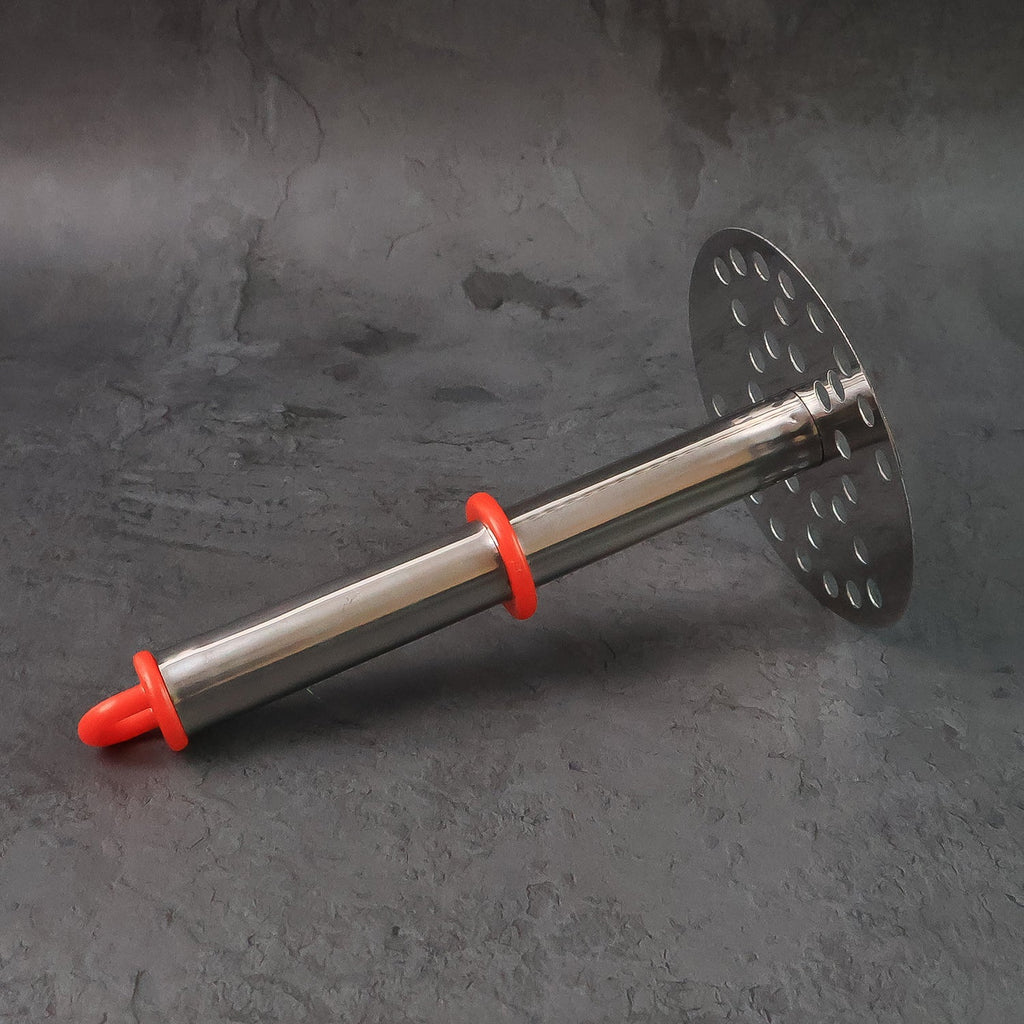 Potato masher held comfortably demonstrating ergonomic handle design