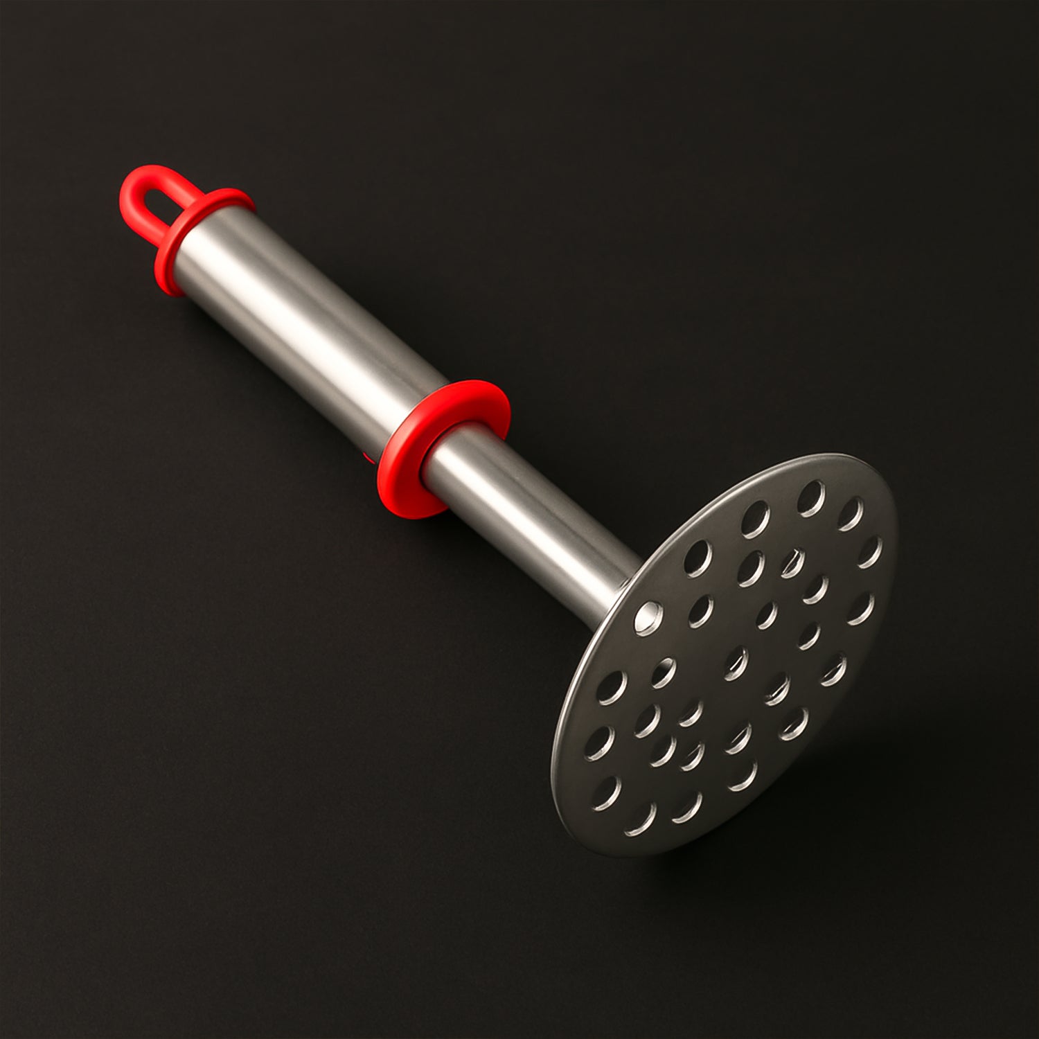 Close-up of wide mashing plate with precision-cut holes on potato masher