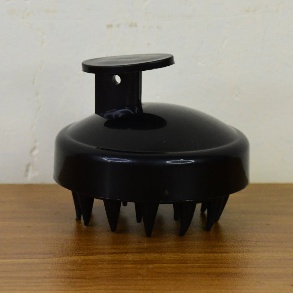 Scalp massager brush styled with hair care products for enhanced hair treatment