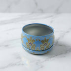 Side view of mandala metal candle container