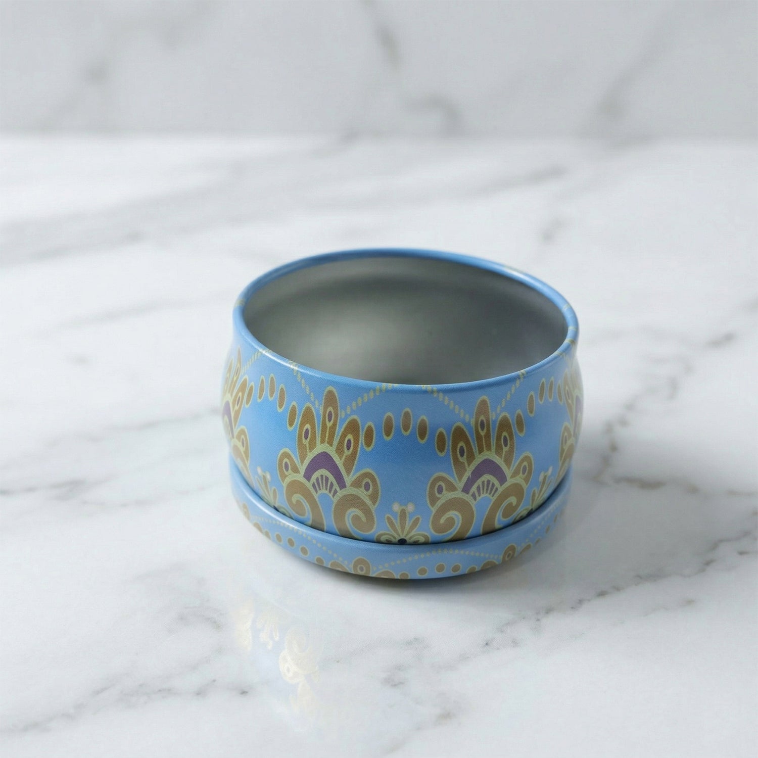 Side view of mandala metal candle container