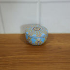 Mandala printed metal candle tin in home decor setting