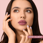 Model applying Merry Mulberry Liquid Lipstick for a matte finish.
