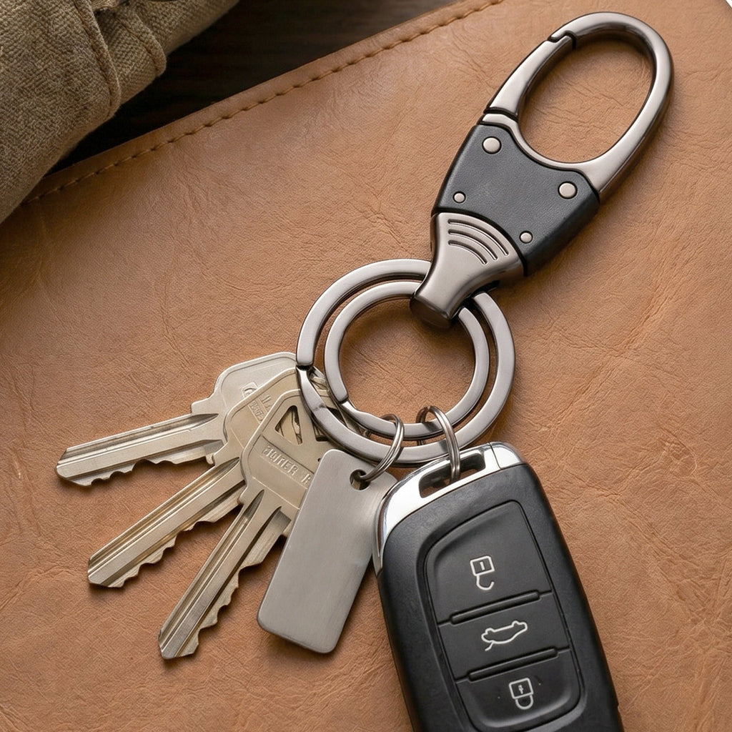Hand holding compact metal key holder with rotating swivel