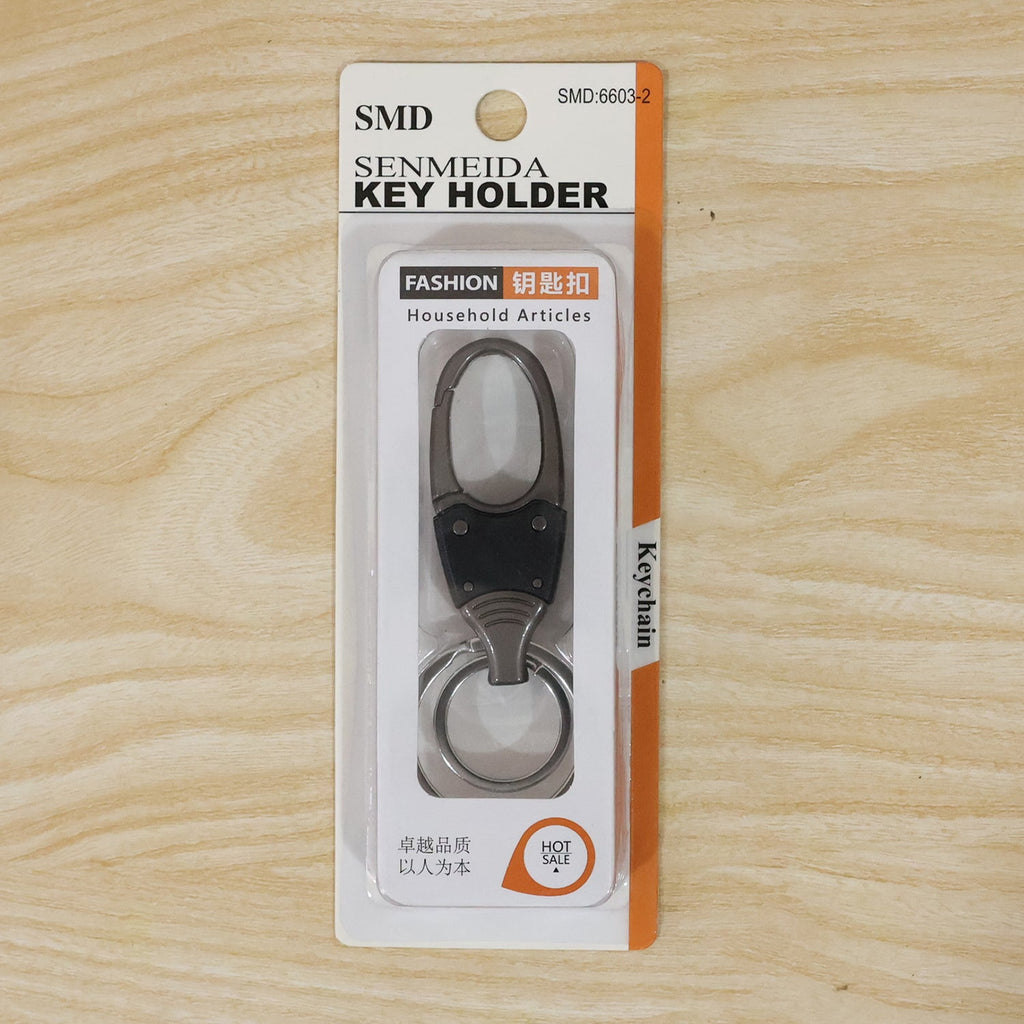 Metal key holder with rotating swivel on plain white background