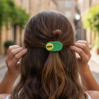 Single decorative hair clip with raised text accent design