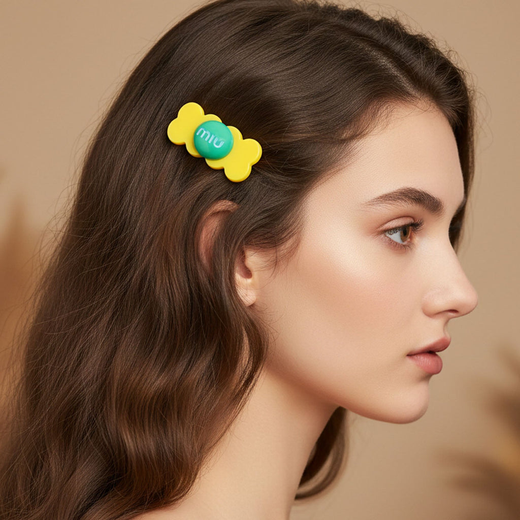 Young girl smiling wearing a colorful candy hair clip in her hair