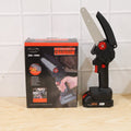 Person using mini cordless electric chainsaw to cut a tree branch