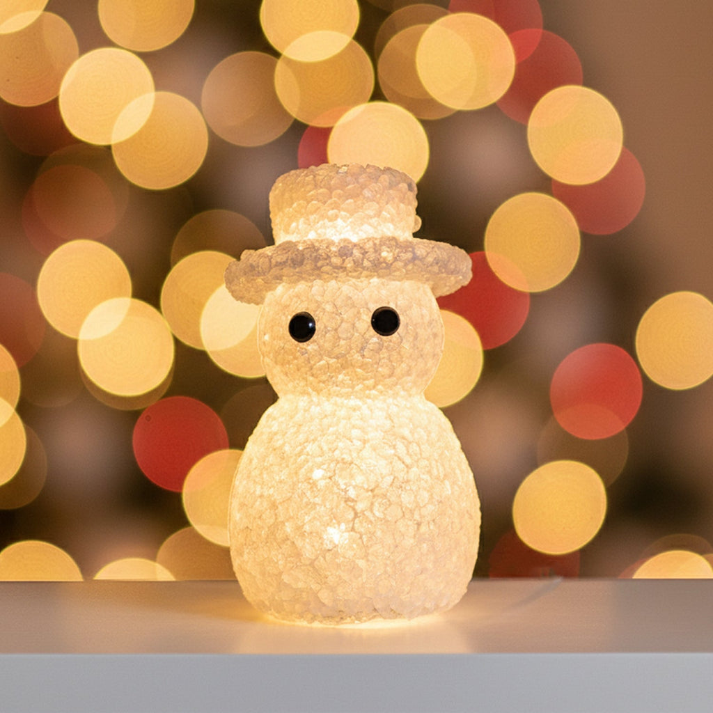 Snowman LED table lamp emitting soft glow perfect for holiday decor