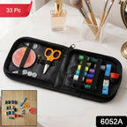Open portable stitching kit revealing various threads, needles, and tools for travel.