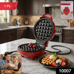 Freshly cooked waffle being lifted from the non-stick Mini Waffle Maker.