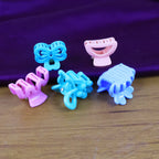 Mini hair claw clips in mixed vibrant colours scattered on a surface.