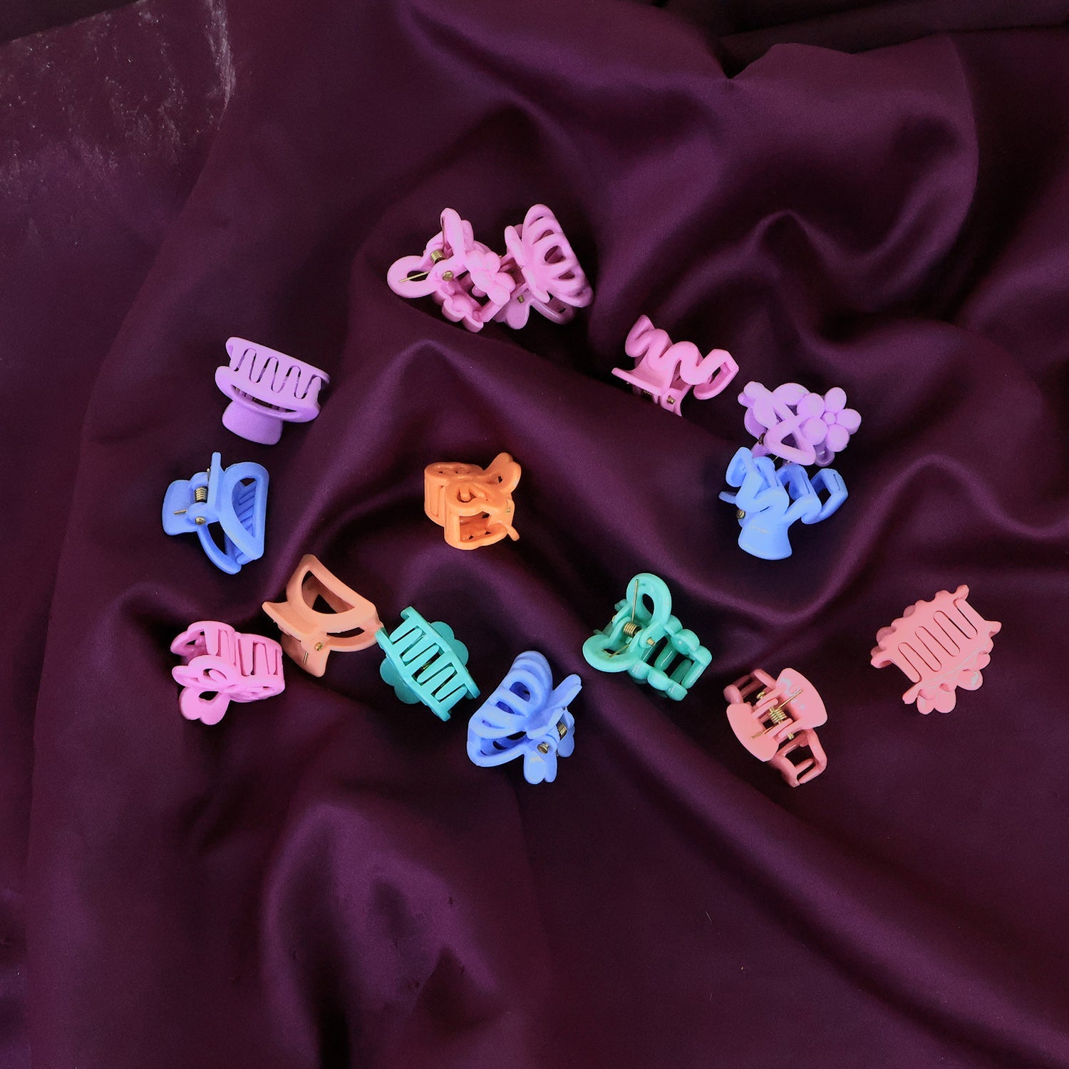 Brightly coloured mini hair clips for kids displayed neatly in a row.